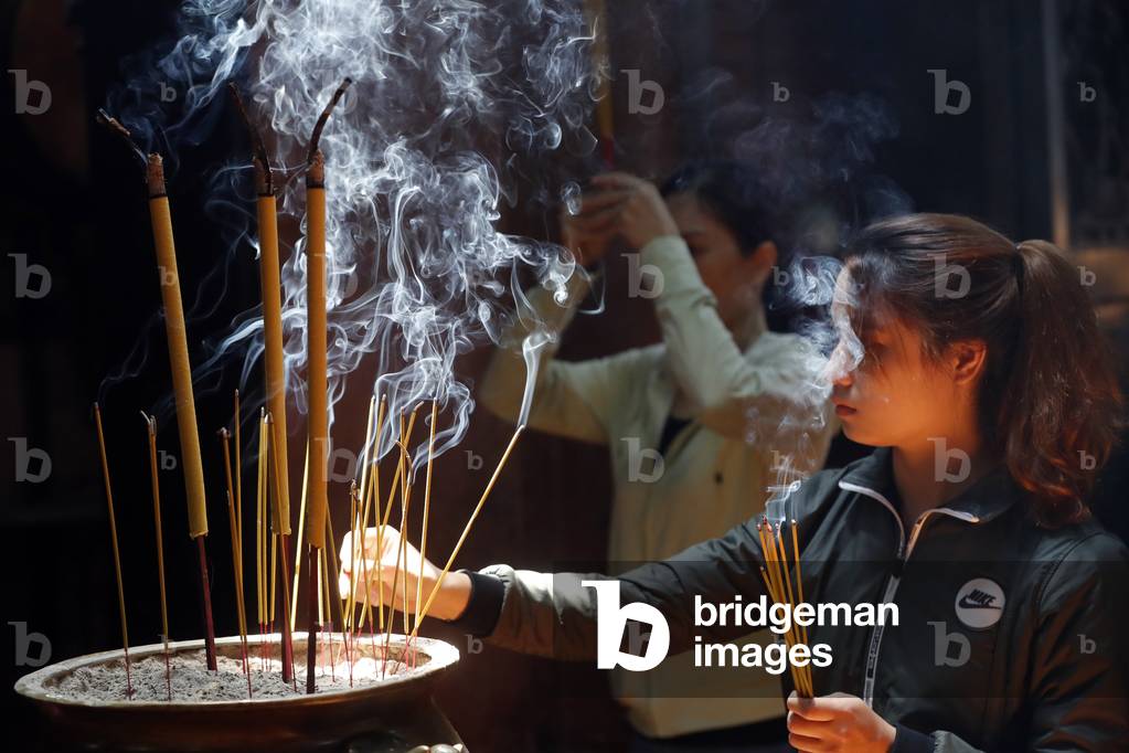 Taoist temple. Emperor Jade pagoda (Chua Phuoc Hai).  Buddhist Worshipper. Burning incense sticks. Ho Chi Minh city. Vietnam.  (photo)