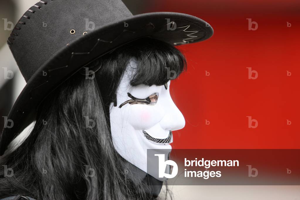Protester wearing a Guy Fawkes mask , trademark of the Anonymous