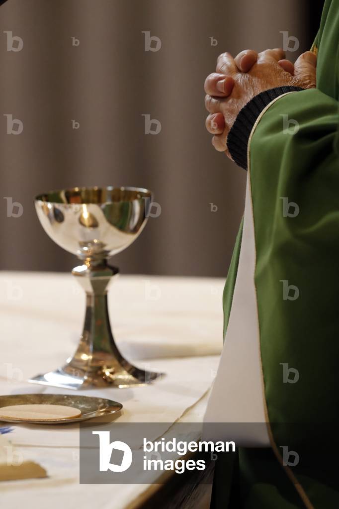 Catholic church during covid-19 epidemic. Sunday mass.  Priest at eucharistic celebration.  Sallanches.  France.