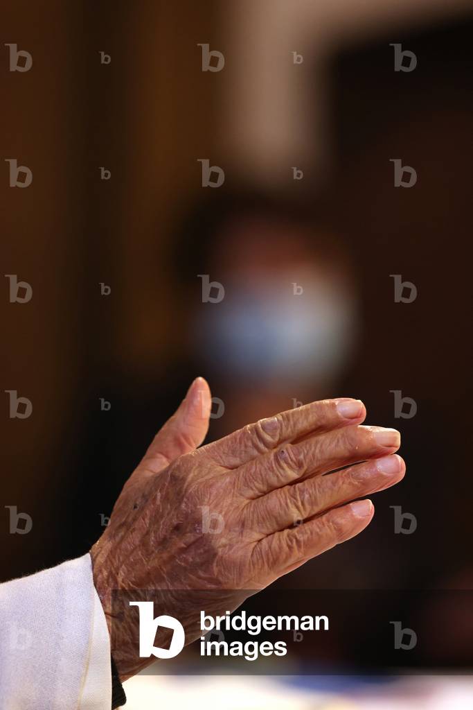 Catholic church during covid-19 epidemic. Sunday mass.  Priest at eucharistic celebration.  France.