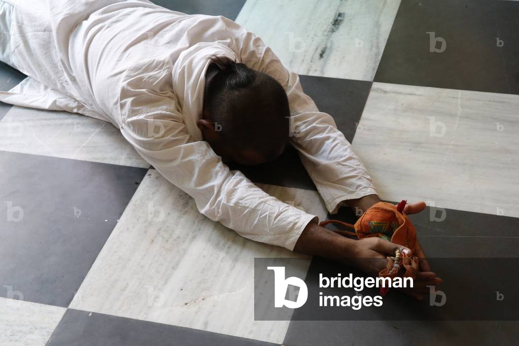 Devotee prosternating at Krishna-Balaram temple, Vrindavan, Uttar Pradesh. India