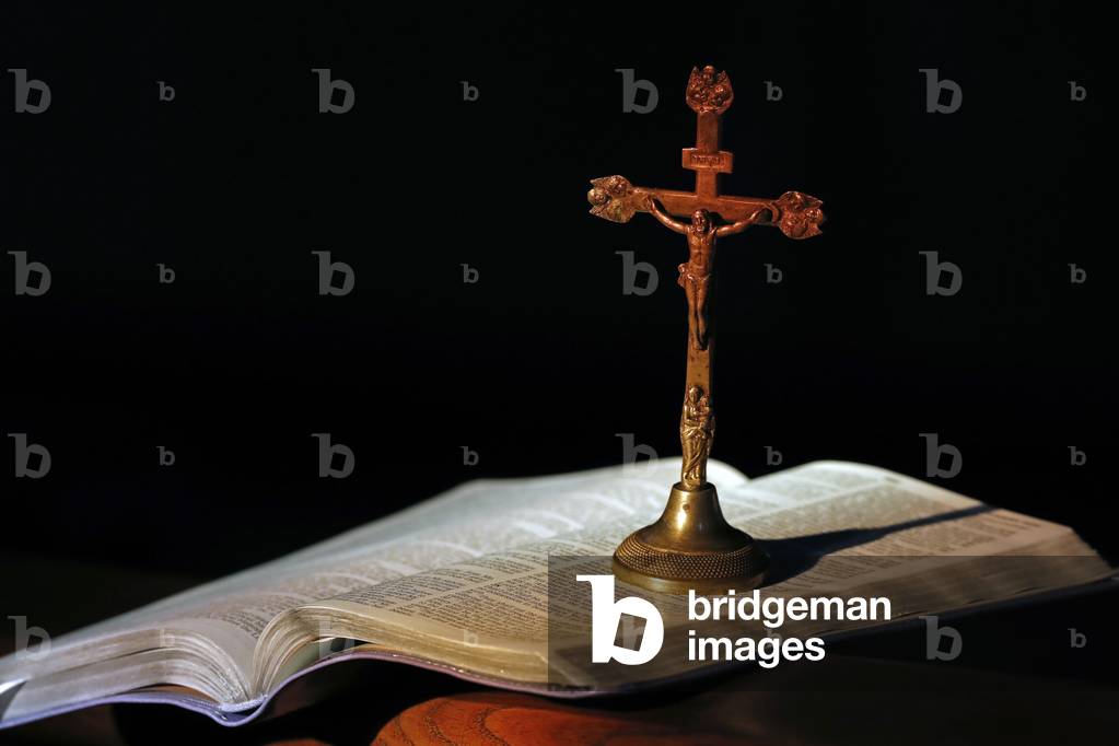 Open bible and crucifix in a church.  (photo)