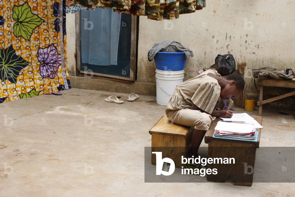 School girl doing homework, Lome, Togo