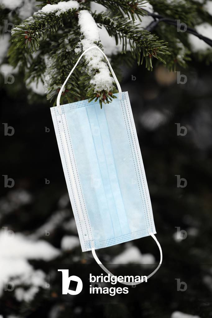 Surgical mask on Christmas tree. Coronavirus ( Covid-19) epidemic.  France.