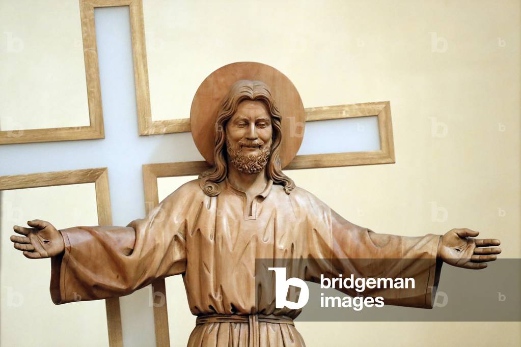 Statue of Jesus in front of the Cross.  Taninges. France. (photo)