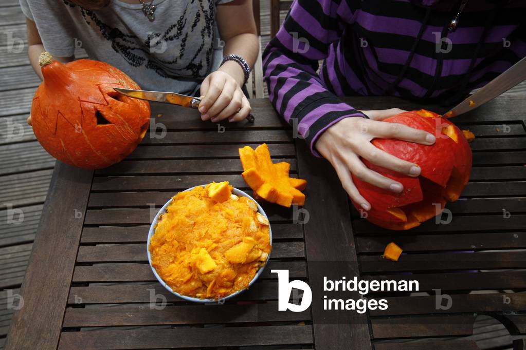 Girls preparing pumpkins for Halloween Sadirac France