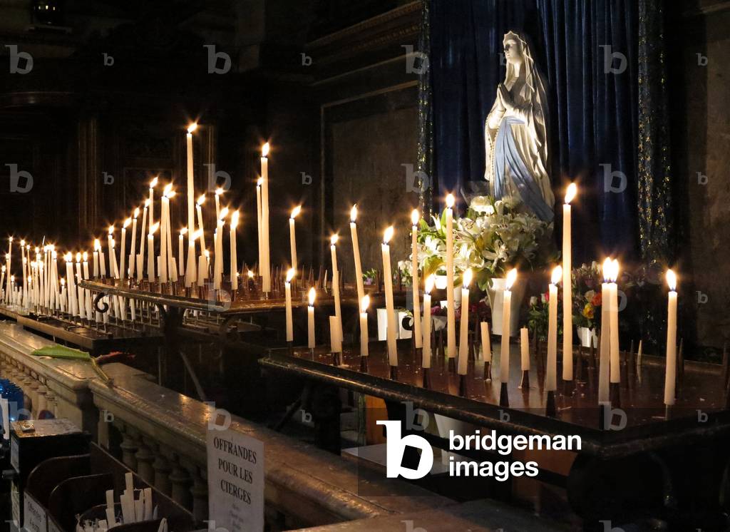 Candles in La Madeleine church Paris France