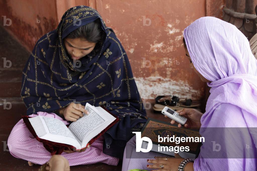 Women reading the Quran at Jamma Masjid (Delhi Great Mosque), Delhi, India