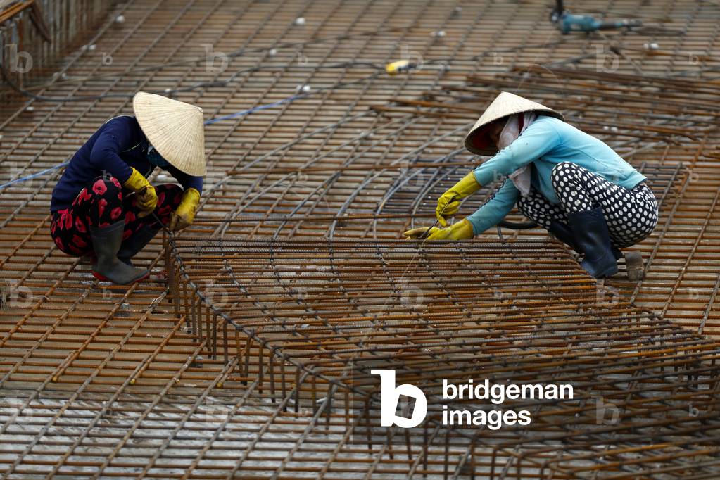 Construction site, Women working with steel rebar for concrete reinforcing, Quy Nhon, Vietnam (photo)