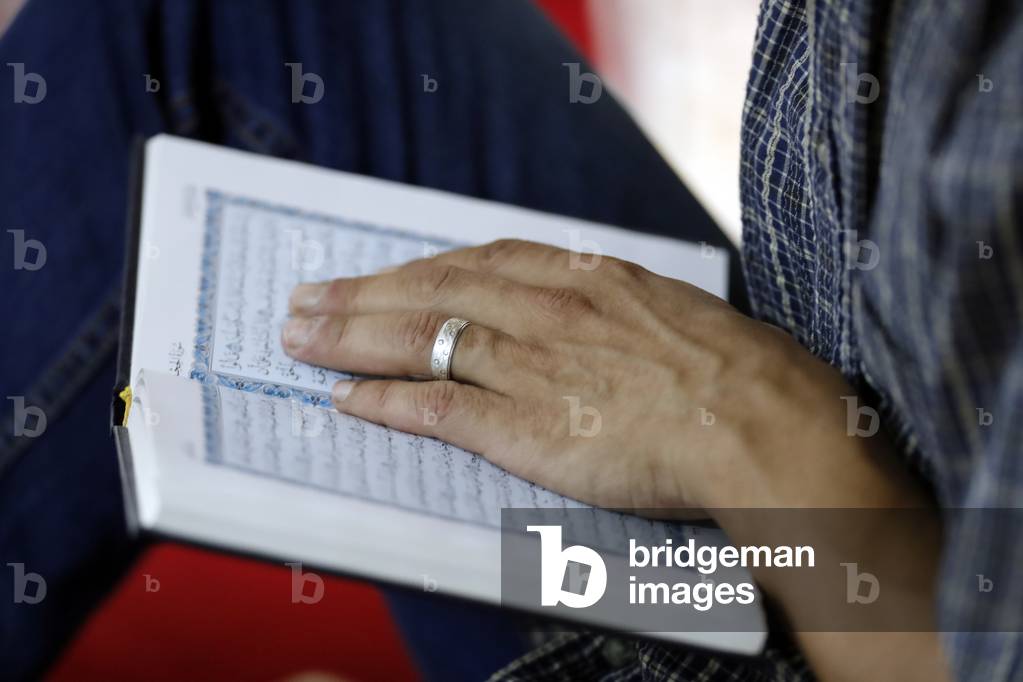Muslim man reading the Noble Quran, Close-up, Hanoi, Vietnam, 2019 (photo)