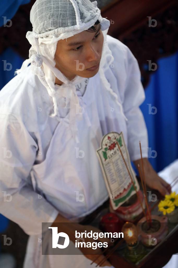 Cao Dai temple, Worshipper at service, Phu Quoc, Vietnam (photo)