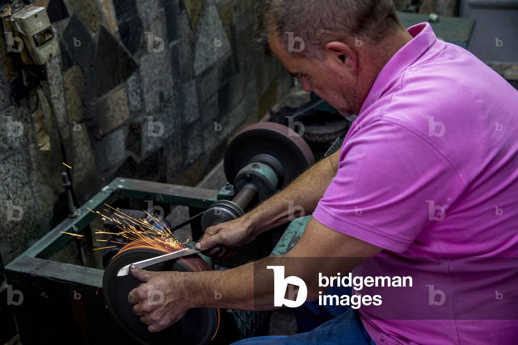 Knife maker XHEMAJILI HOTI, at work in Prizren, Kosovo, received loans from AFK microfinance (photo)