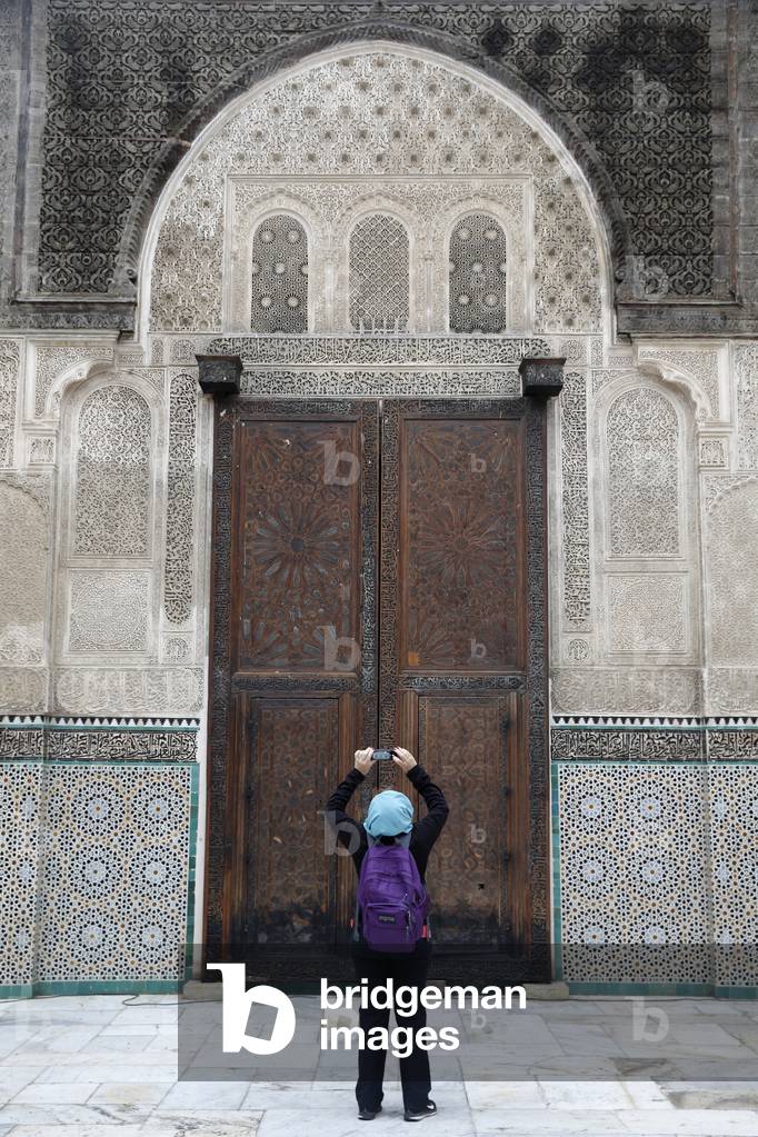 Tourist in Bouanania medersa, Fes, Morocco (photo)