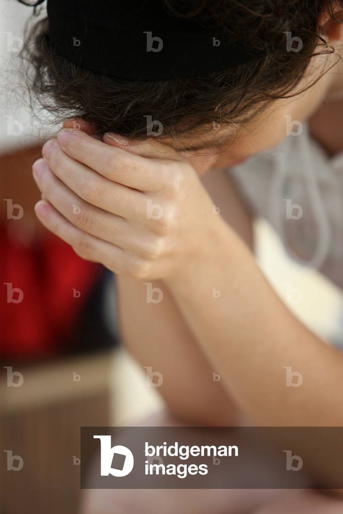 Young woman praying Madrid Spain