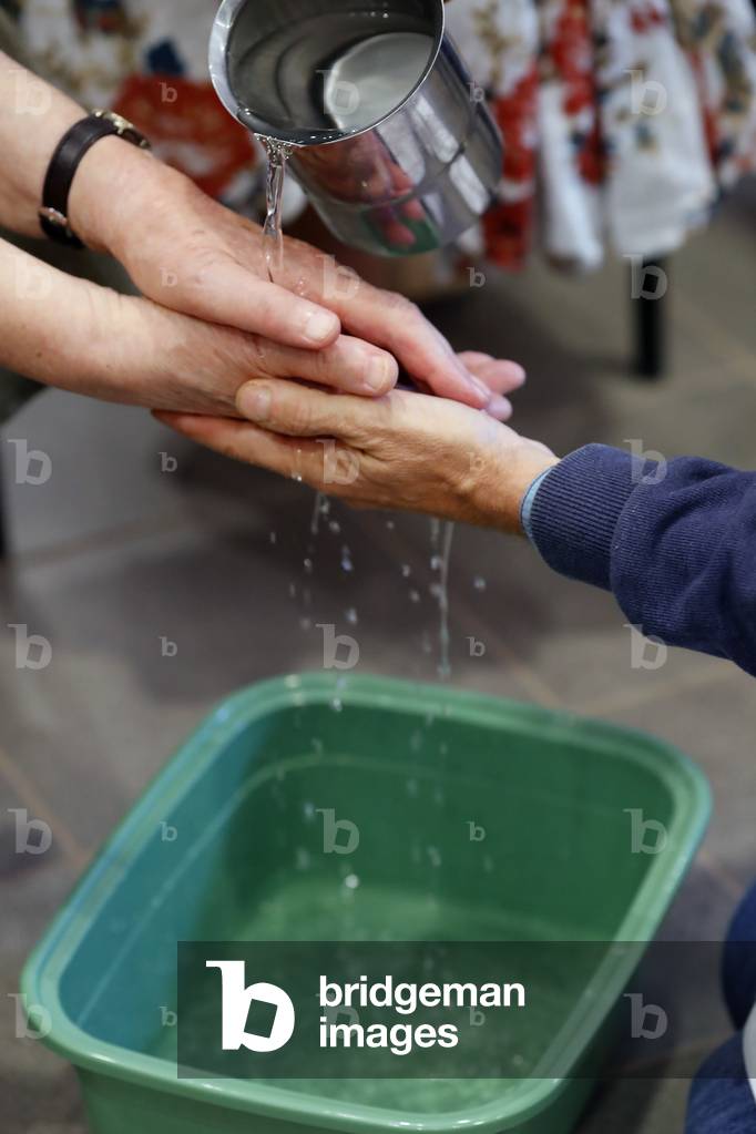 Feet washing ritual in a catholic church, Paray le Monial, France (photo)