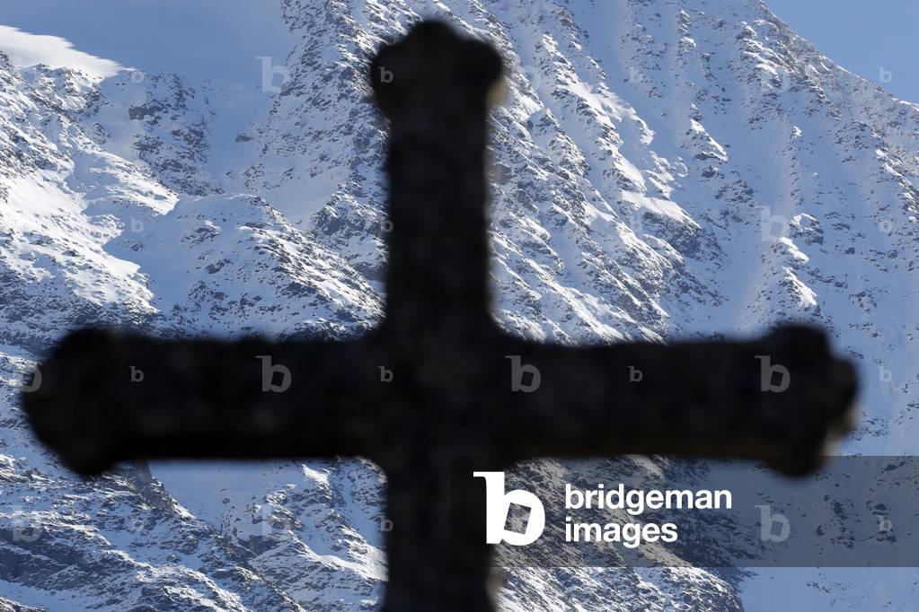 Mony Blanc massif. Franch Alps. Silhouette of christian wooden cross.  France.
