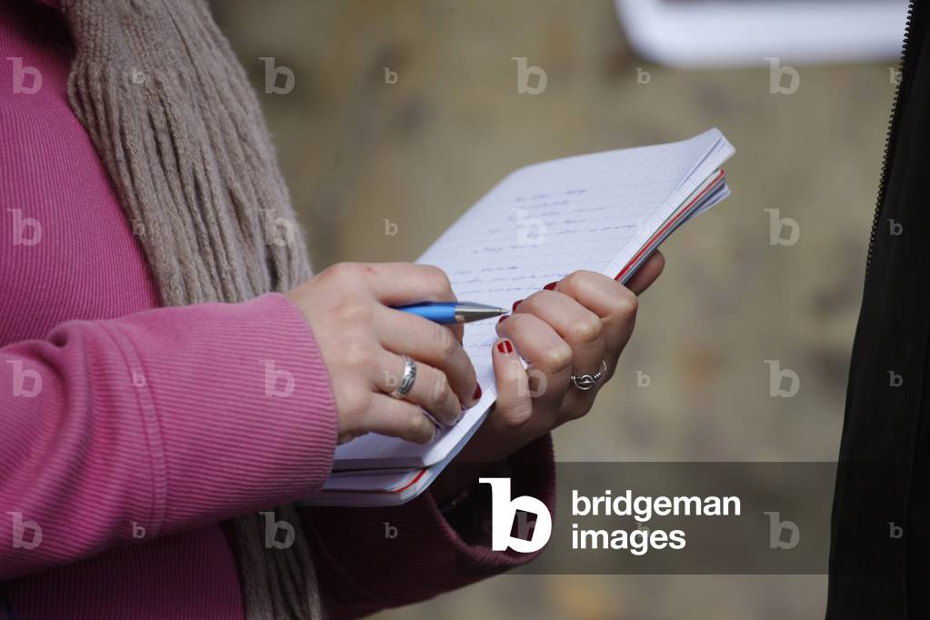Woman taking notes in a notebook Paris France