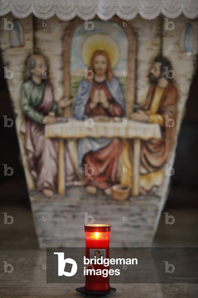 Padre Pio candle in front of an altar, Depressa, Italie