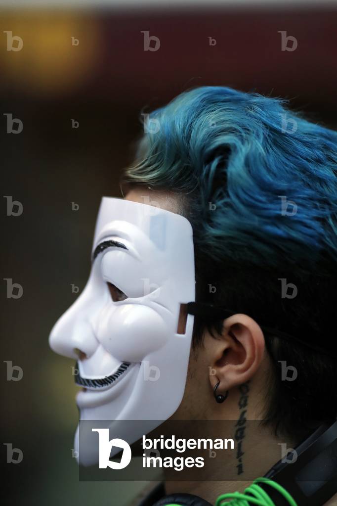 Man wearing Anonymous mask.