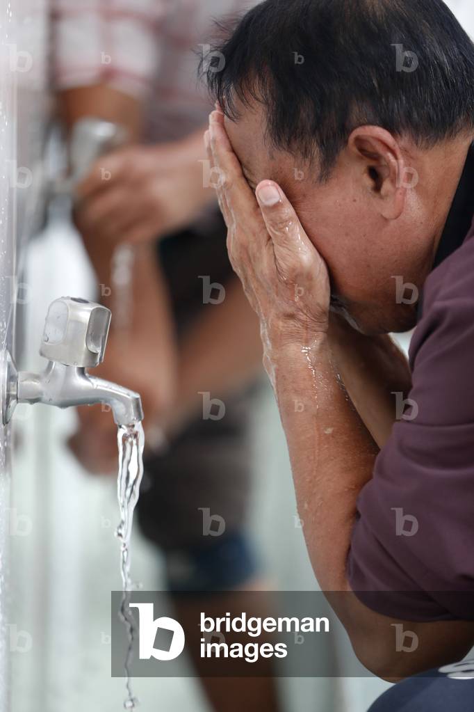 Masjid Al Rahim Mosque, Ritual purity in Islam, Muslim performing Wudu ( ablution ), Ho Chi Minh City, Vietnam (photo)