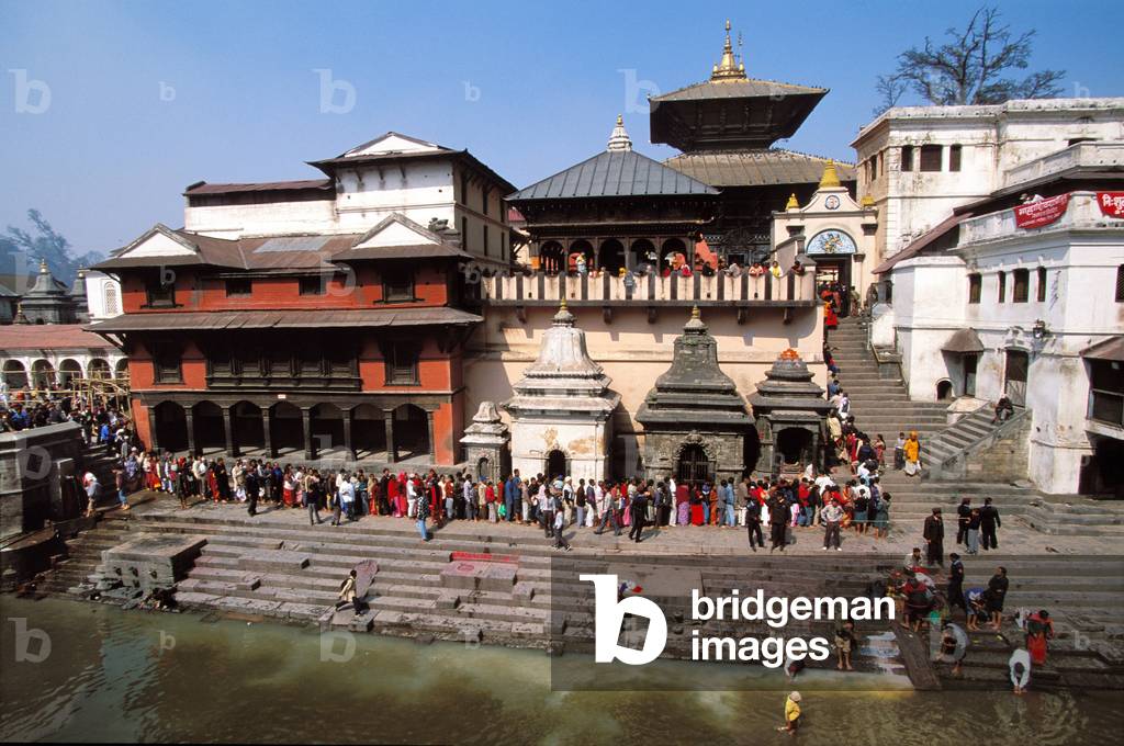 Temple and devotees on the Bagmati river bank in Pashupatinath holy city, Pashupatinath, Nepal