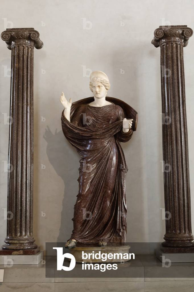 Louvre museum, Paris, France. Woman praying between two Ionic columns, porphyry, with restorations in ancient marble.