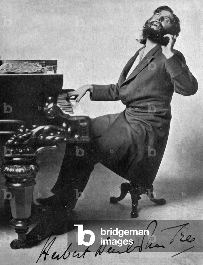 Sir Herbert Beerbohm Tree as Svengali seated at a piano in George du Maurier 's 'Trilby'