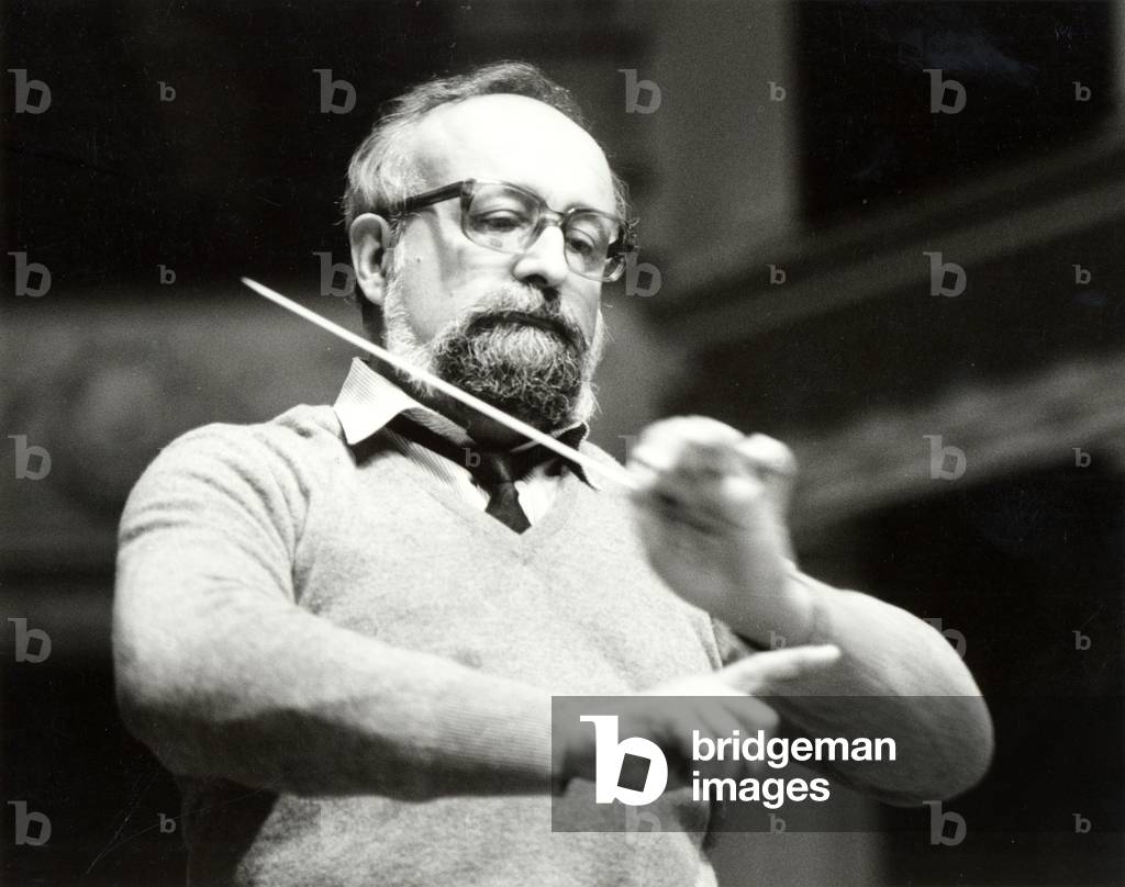 Krzystof Penderecki conducting with baton, 1989 (b/w photo)