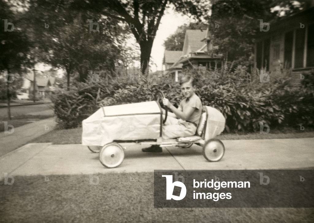 Boy in an Early Soap Box Derby Car, 1938 (silver print photograph)