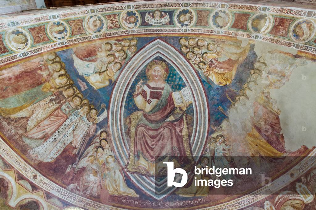 Clessing Christ in majesty within the almond and holding the book with the words 