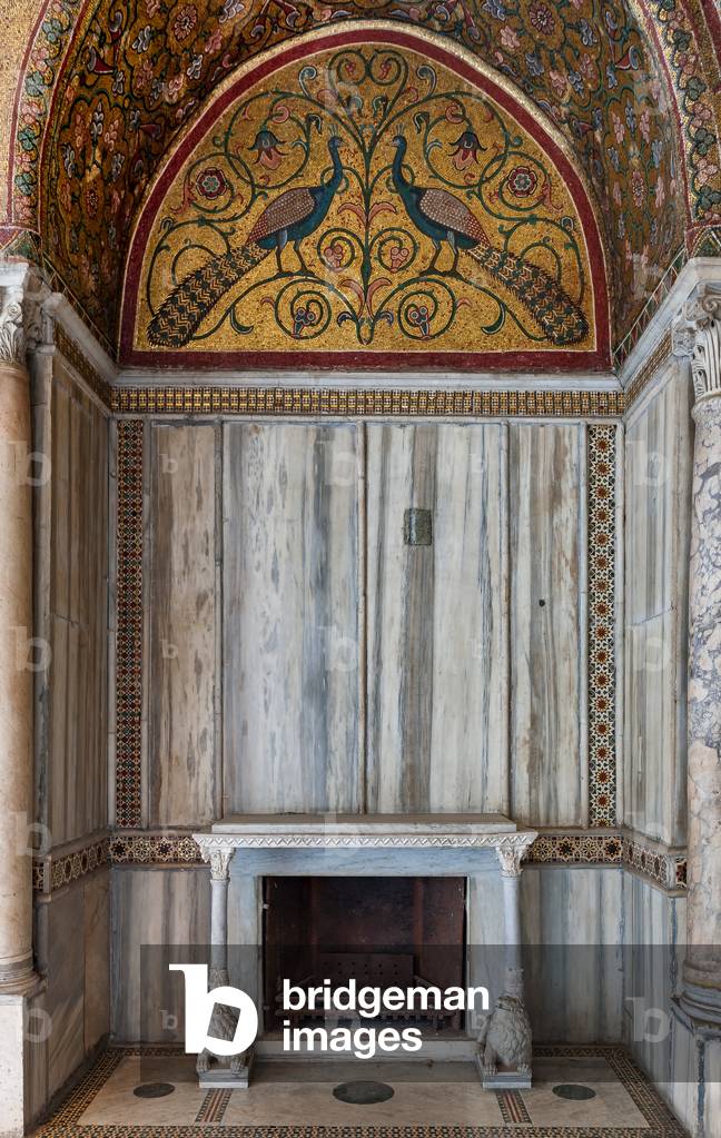 Palermo, The Royal Palace or Palazzo dei Normanni (Palace of the Normans), Pisana Tower, the King Roger Room: view of the Room, detail of a niche with fireplace with two lion sculptures supporting the shelf, a lunette with a mosaic representing peacocks, rich marble coverings and angular columns, Greek Byzantiene style, XIII century