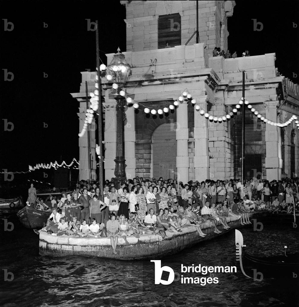 Procession of gondolas accompanied by music on the Grande Canal, during the “Fresco notturno” festival in Venice. 1960 years