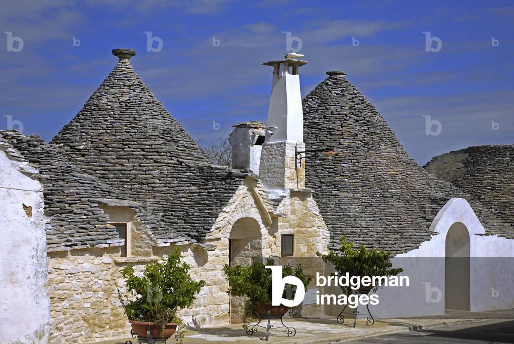 Italy: Puglia: town of Alberobello with its beehive-shaped cottages with a conical roof, dry stone (trulli) ba