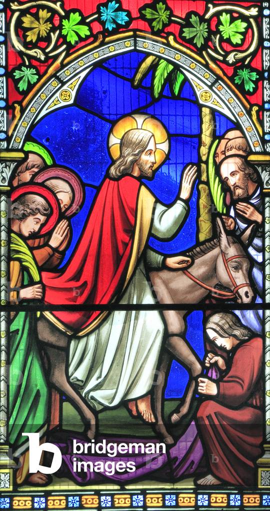 Story of Easter, Entry into Jerusalem, Jesus rides on a donkey, crowds welcome him, spread clothes before him, Palm Sunday, stained glass window by William Warrington, 1854, Gunthorpe, Norfolk, England (photo)