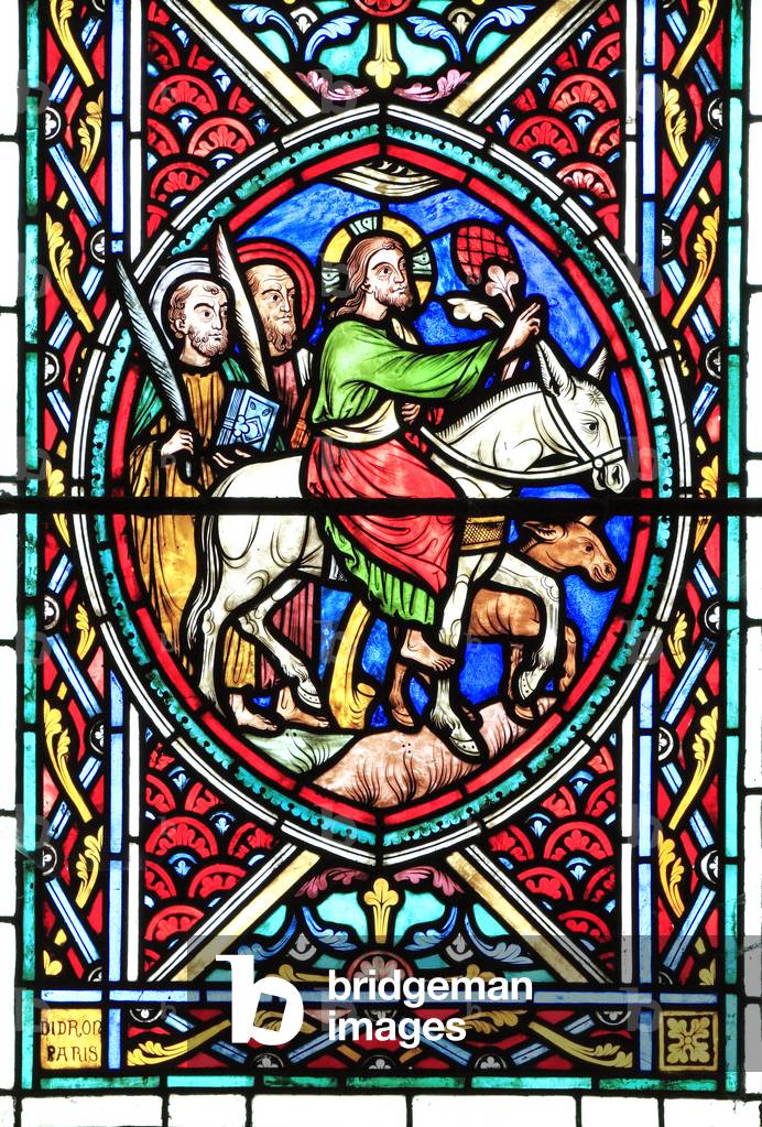Jesus Christ rides into Jerusalem on a donkey, with two disciples, Palm Sunday, Passion Window by Adolph Didron, 1860, stained glass, Feltwell church, Norfolk, England, UK. The Easter Story