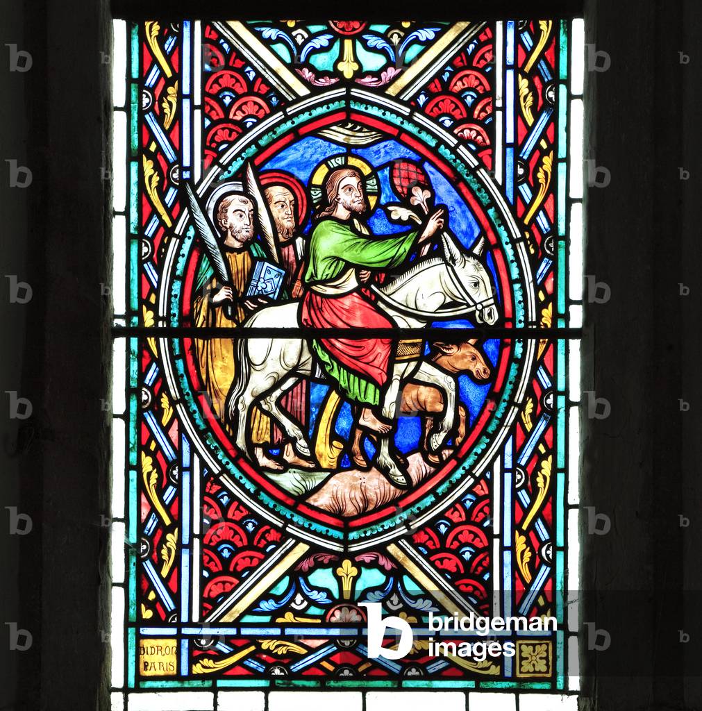 Jesus Christ rides into Jerusalem on a donkey, with two disciples, Palm Sunday, Passion Window by Adolph Didron, 1860, stained glass, Feltwell church, Norfolk, England, UK. The Easter Story