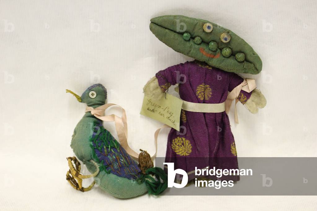 Miss Green Peas rag doll, head is in the shape of a pea pod, and she leads her pet duck by a pink satin ribbon, 1920s
