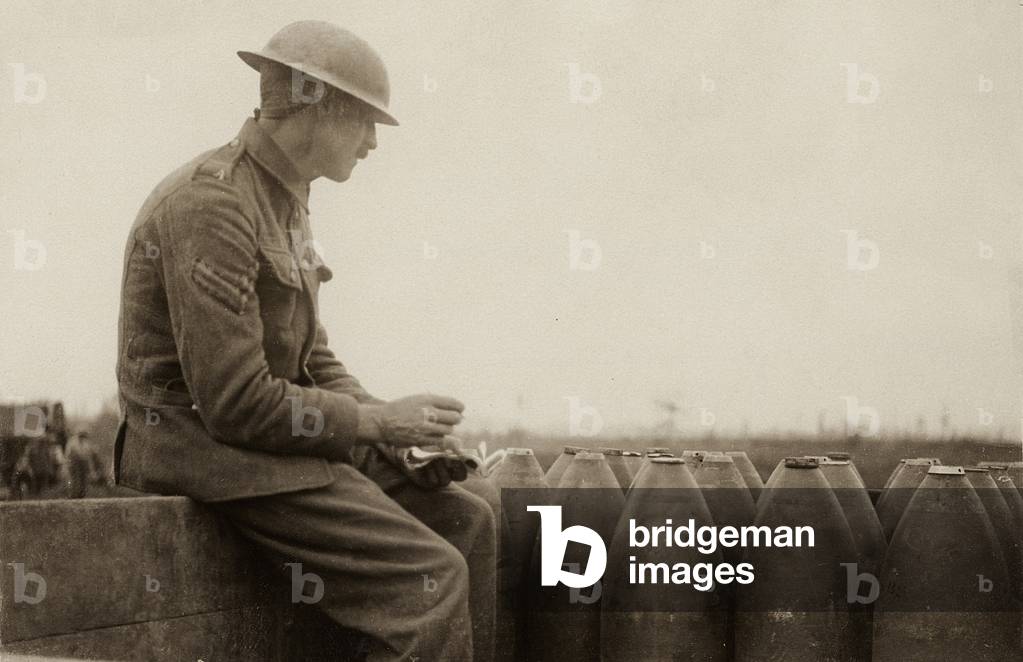 British corporal checking shells arriving on a light railway, Western Front, 1914-18 (b/w photo)