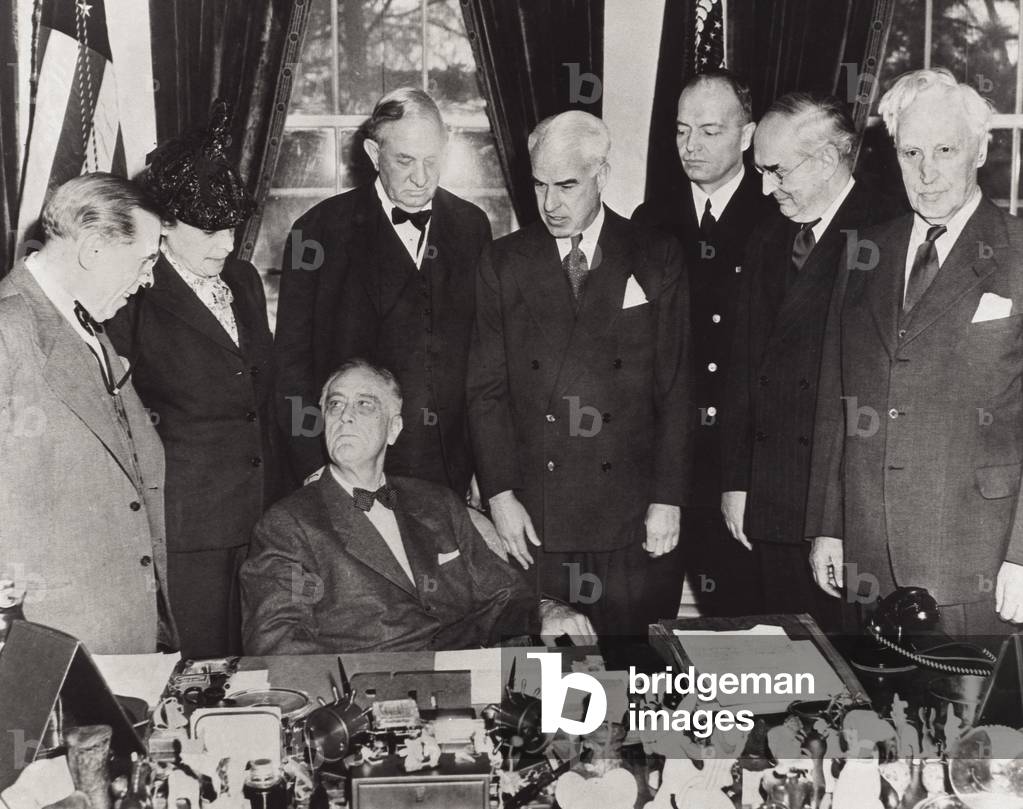 US President Franklin Delano Roosevelt (1882-1945) (seated) at the San Francisco conference surrounded by United Nations delegates, which will see the birth of the United Nations Organisation (UNO) following the signing of the UN Charter, June 1945 (b/w photo)
