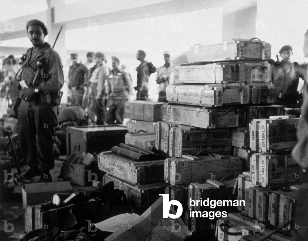Cuban Revolution: members of the revolutionary movement led by Fidel Castro with crates of arms. 1959-1960 Cuba (b/w photo)