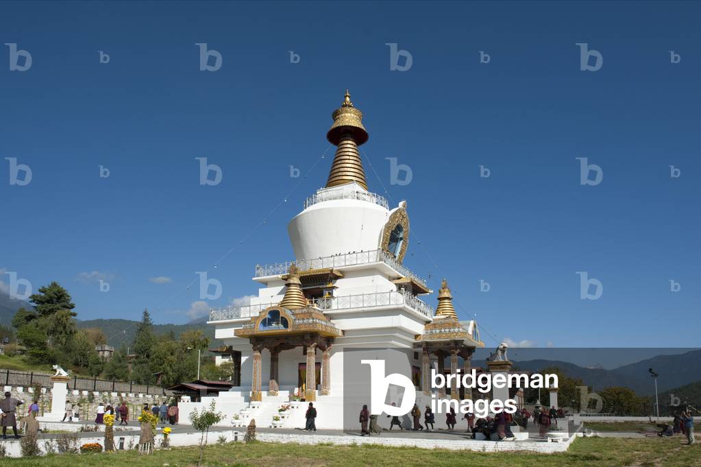 Tibetan Buddhism; believers circling the large white stupa; Memorial Chorten; capital of Thimphu; the Himalayas; Kingdom of Bhutan; South Asia; Asia