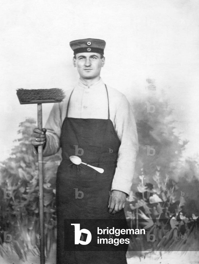Soldier with a broom, an apron and a hanging spoon.