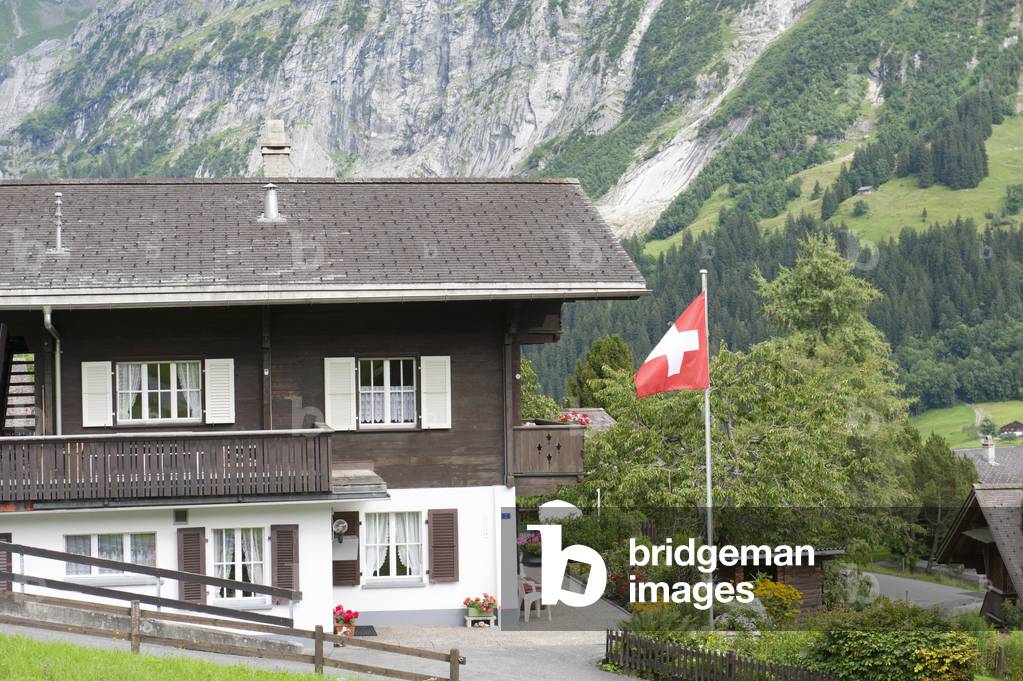 Building; Swiss national flag; Grindelwald; Bernese Oberland; Canton of Bern; Alps; Switzerland; Europe