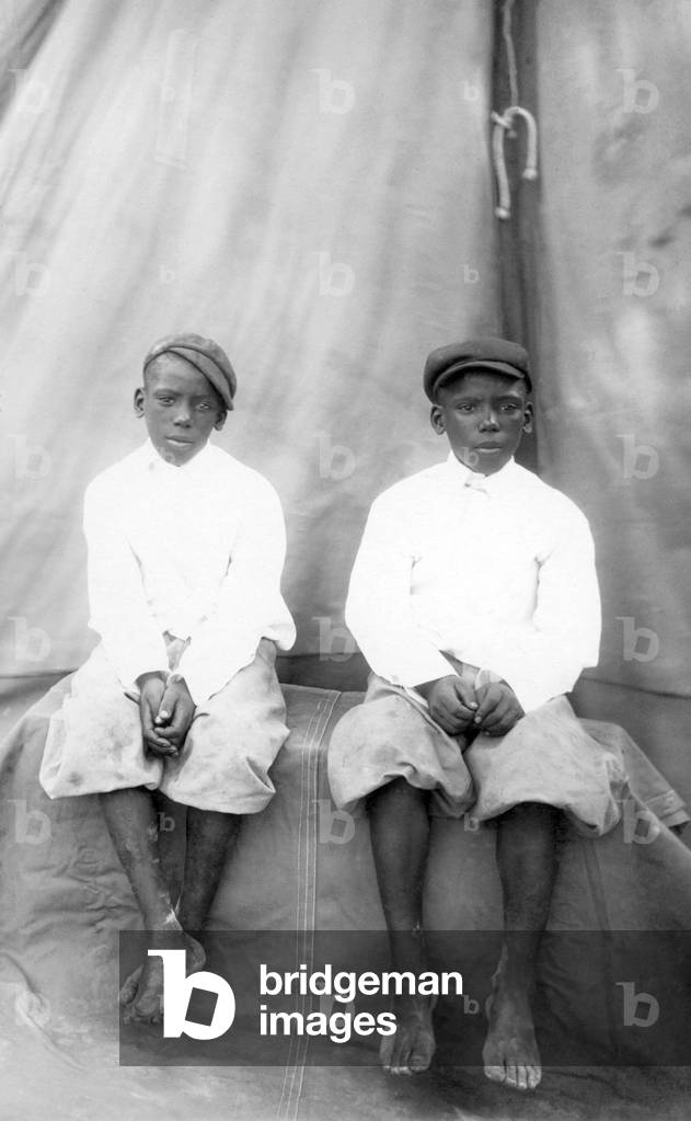 Portrait of two African boys wearing European clothing.