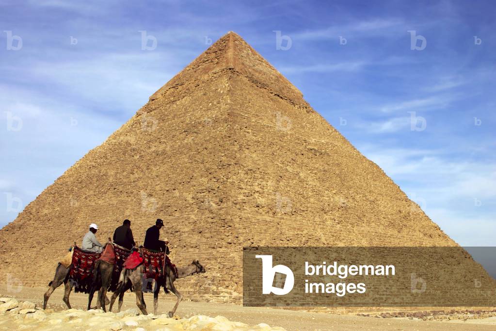 View of the Pyramid of Chephren (Khephren or Chefren, 2630-2510 BC) archeological site of Gyza (Guizeh, Guiseh, Giza) near Cairo in Egypt with men on camels, Africa.
