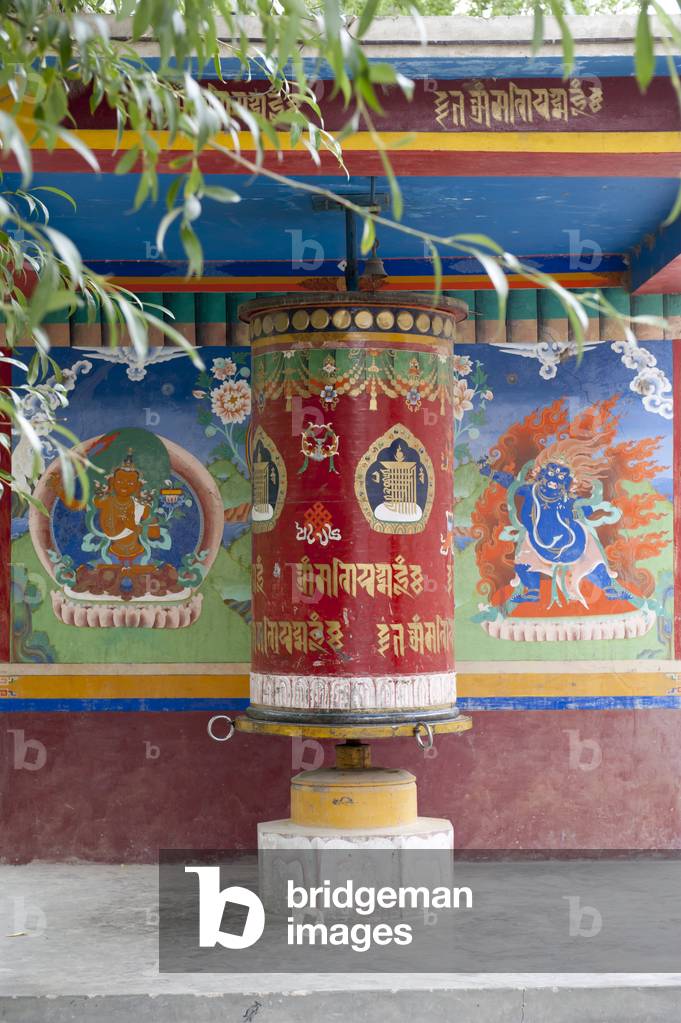 Tibetan Buddhism; large colorful prayer wheel; mural paintings; below the Spituk Monastery near Leh; Spituk Gompa; Ladakh region; Jammu and Kashmir; India; South Asia; Asia