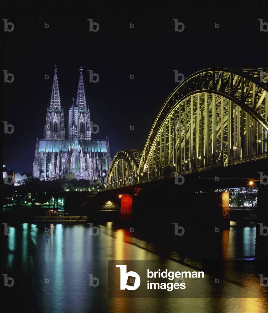 View of the Deutz Bridge over the Rhine and the Cathedral, at night, Cologne - Arches of Deutz Bridge crossing the Rhine River in front of Cologne Cathedral at night, Cologne, North Rhine-Westphalia, Germany, Europe