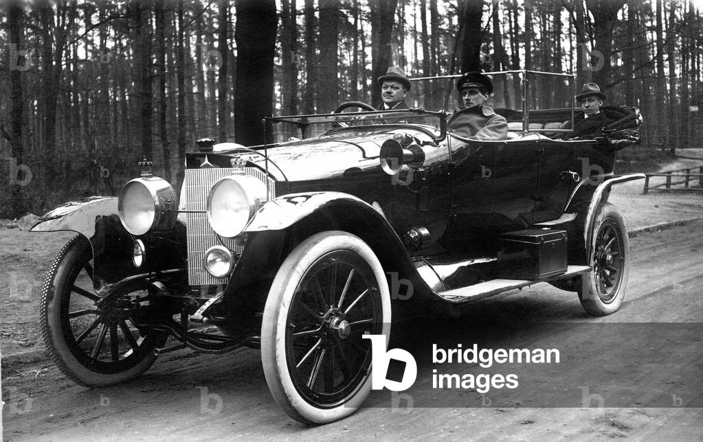 Men in an old vintage car.