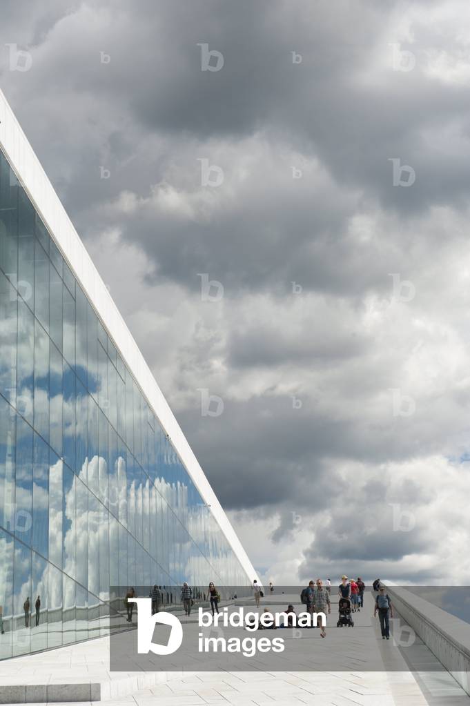 Modern architecture; inclined plane; dark clouds reflected in the glass; New Opera House; Operaen; Oslo; Norway; Scandinavia; Northern Europe; Europe