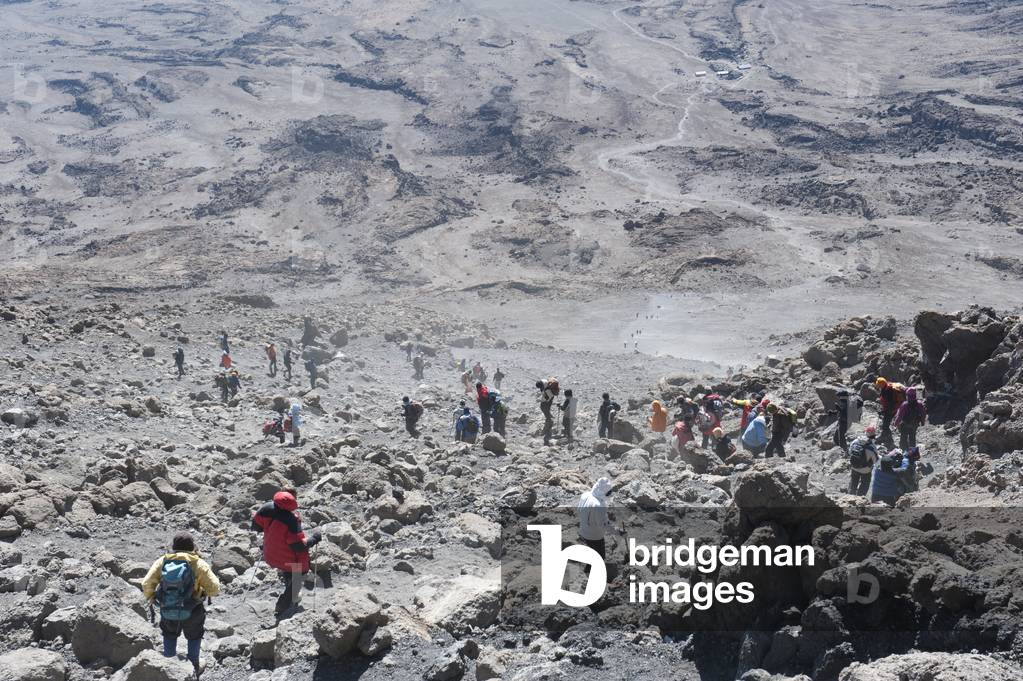 Mountaineering; mass tourism; many mountaineers during the dusty descent from Gilman's or Gillman's Point to Kibo Hut; summit of Mount Kilimanjaro; Marangu Route; Tanzania; East Africa; Africa